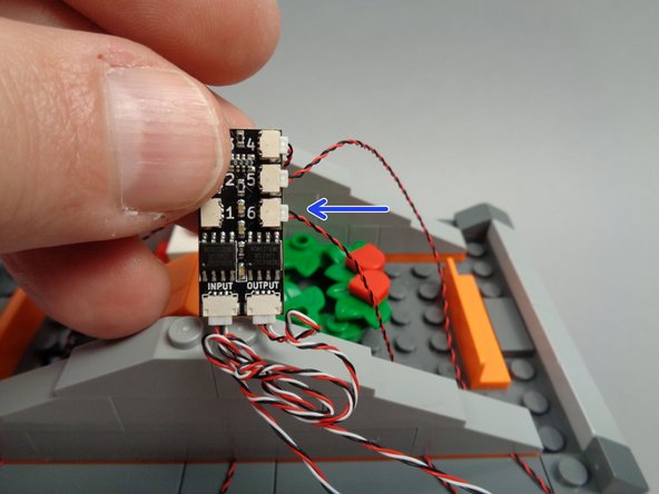 As shown by the arrow in the second photo for this step, connect the front banner light wire to plug #6 on the BRANCH06X driver board.