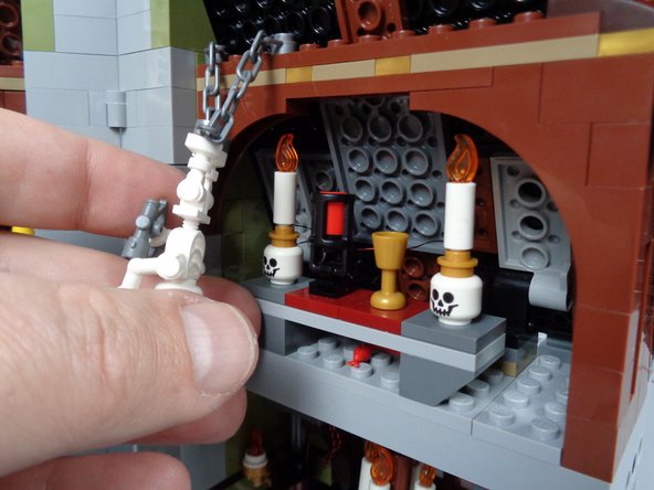 As shown in the third photo for this step, replace the attic candle table.