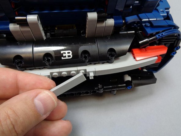 As shown in the three photos for this step, re-assemble the rear right turn signal and tail light mount.