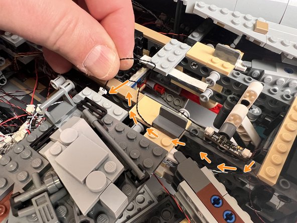 The orange arrows in the first photo for this step show how to route the wire connected to the &quot;IN&quot; plug on the magnetic switch circuit board.