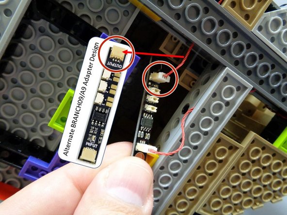 Now you will connect the red control wire coming from the top of the tower to the open plug on the BRANCH09 adapter board under the castle base.  See the red circle in the first photo.