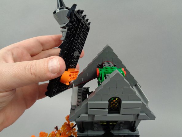 As shown in the photos for this step, re-attach the two roof sections of Jack's house.