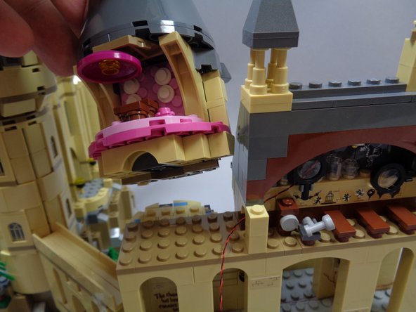As shown in the first photo, remove the section of the castle that contains Umbridge's Office.  The section should come off in a single piece.