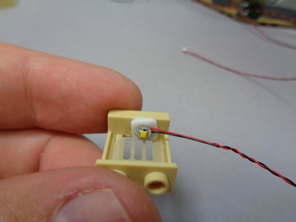 Repeat the process as shown to mount the remaining two white lights in the two upper windows.