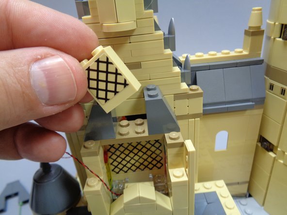 After removing the parts shown in the three photos, you should expose a gap as shown by the red arrow in the third photo.  This is where you will run the light wires in the next step.