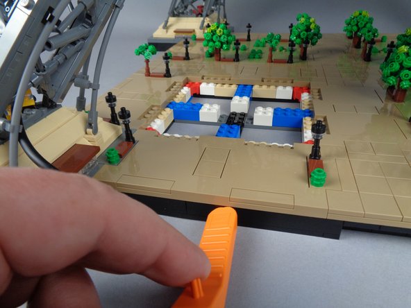 The photos for this step show how you can use your LEGO brick separator to help loosen edge panels, where you are not able to press from beneath.