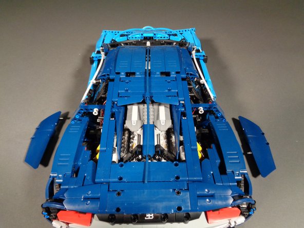 As shown in the three photos for this step, begin disassembling the panels holding the rear center window in place.