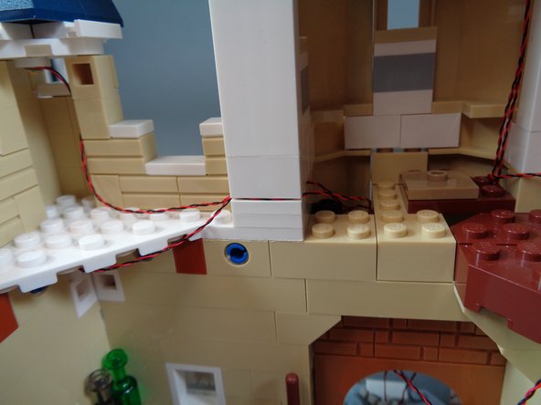 As shown in the third photo, you can lift the white wall section if desired to help hold the kitchen ceiling light wire in place.  Just make sure the wires run between, not on top of, any studs.