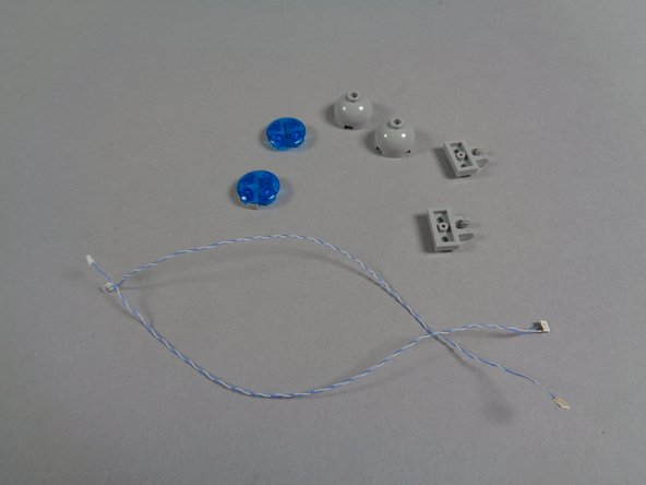 As shown in the first photo for this step, take the two blue LED lights from the &quot;Blue Roof Lights&quot; bag that have the shorter wires, and disassemble both rear blue roof lights as you did with the front two.