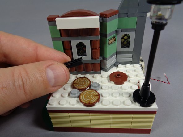 As shown in the third photo, remove the black grille piece.