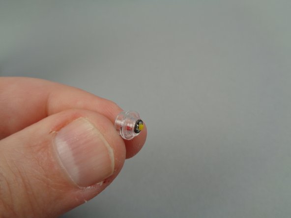 As shown in the first photo for this step, pull the light wire back through the transparent plate until the LED light sits directly on the stud.