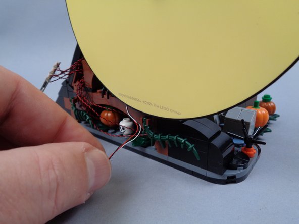 If you are using the crescent moon frame, you may need to remove the round 1x1 plate on the back side of the moon (this is the part closest to the round end of the pin) in order for the frame to re-attach to the wave.