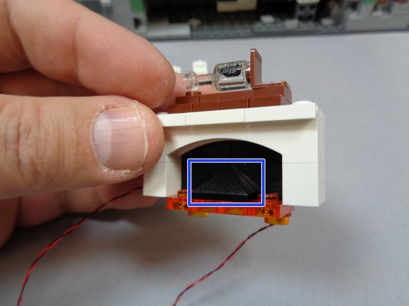 As shown by the two blue circles in the second photo, make sure the round plates are at the back side of the fireplace.