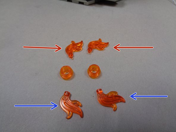 Remove the two flame pieces from the transparent orange round plates as shown by the red arrows in the first photo.