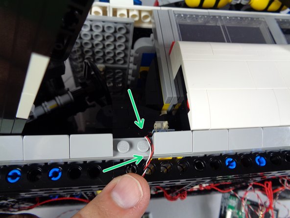 As shown in the first photo for this step, remove the slope from the side frame and route the switch wire between, not on top of, the studs.