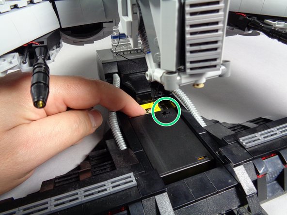 As shown in the second photo, remove the center plate from the support stand.  There is a compartment inside designed to hold the battery pack.