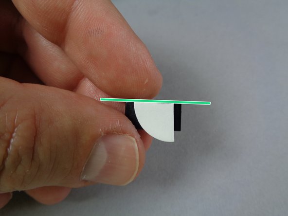 As shown in the first photo for this step, attach the last cut glue disc piece to the last 1x2 black tile.