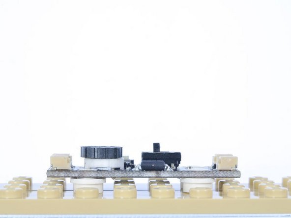 You can use four 1x1 round plates or bricks to mount the LEC to any LEGO surface.  The LEC takes up a 2x6 area.