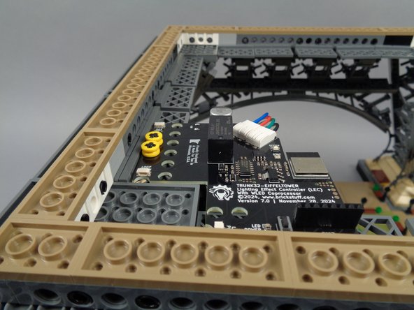 Your main controller should now look like the second photo for this step: firmly held in place in the top corner of your tower base.