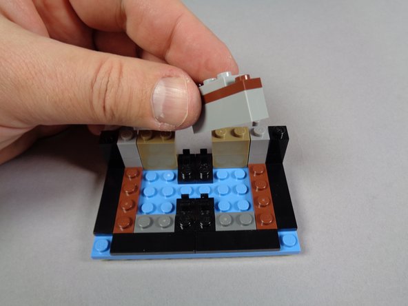 As shown in the photos for this step, continue disassembling the marquee bottom by removing the front and side inner sections.
