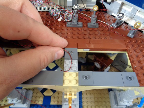 Repeat for the second torch.  When complete, you should have both torches mounted and wires extending out the back of the pillars as shown in the second photo.