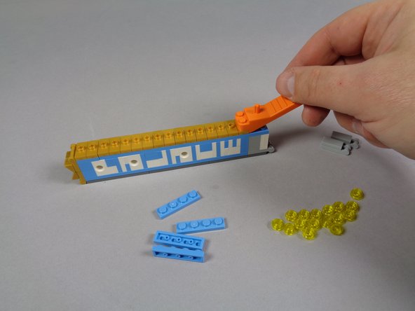 As shown in the second photo, use a brick separator to remove the 16 gold 1x2 jumper plates from the front of the marquee.