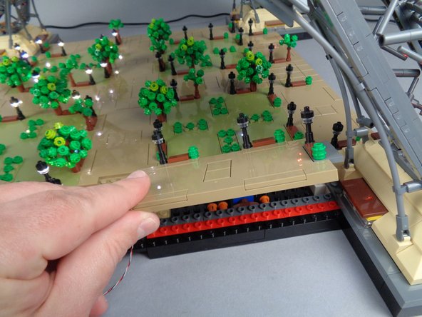 Prepare to work on the lights in Section 3 by removing Panel 3R as shown in the photos for this step.