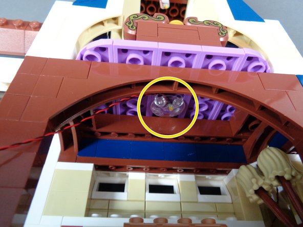 As shown in the photo for this step, mount a second warm white Pico LED light to the ceiling in the magic room (the room below the bedroom) using on of the clear &quot;boat stud&quot; parts in the &quot;Middle Level Interior Lights and Parts&quot; bag.