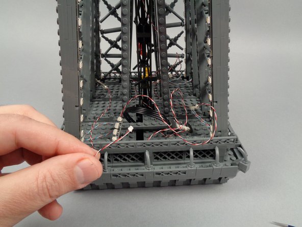 As shown in the third photo for this step, your wire should reach back to where you started with this level: the open rear section of the tower top.