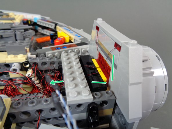 Carefully re-attach the docking bay cap, making sure not to pinch any wires as you re-attach the cap to the main Falcon frame.