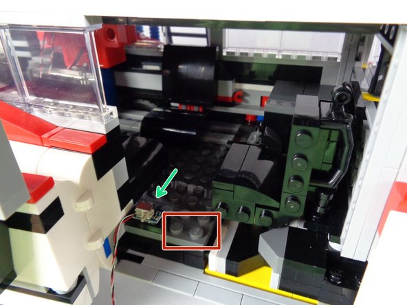 As shown by the green arrow in the second photo, attach the tile and switch on the inside floor of the Ecto-1.