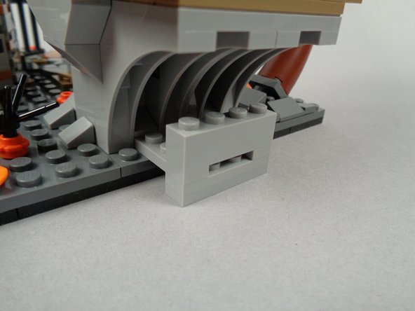 As shown in the third photo for this step, attach the wire support base in the same location from which you removed the two 1x1 slopes.