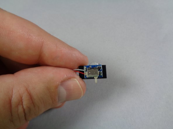 Attach the switch as shown in the third photo, making sure the edge of the switch's circuit board is aligned with the edge of the tile.