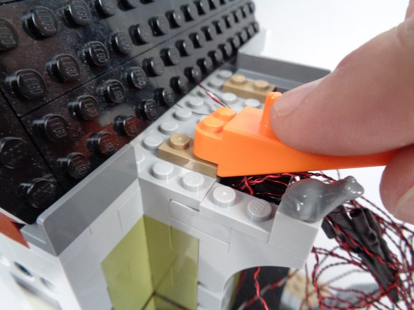 Next you will gather up the wires for the 12 LED lights you connected to the BRANCH12X adapter board and hide them and the adapter board in the space behind the front roof section you removed at the beginning of the installation process.