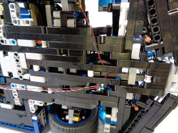 Gently turn your car on its side and place on a flat surface.