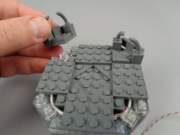 Continue re-assembly by attaching the four corner sections you removed earlier.