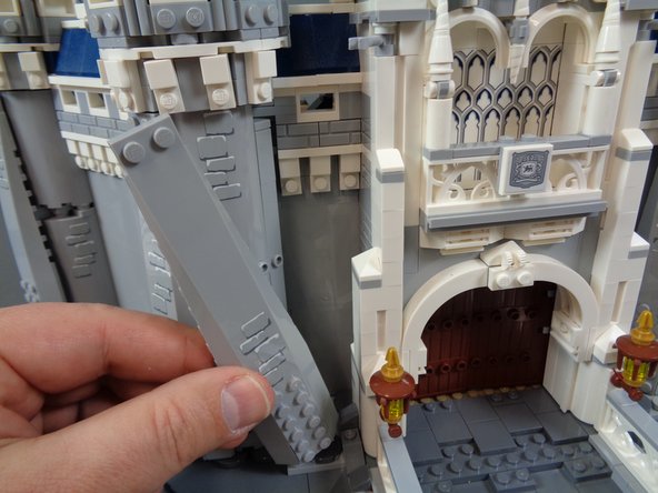 As shown in the second and third photos, re-attach the long slope to the outside of the castle tower.