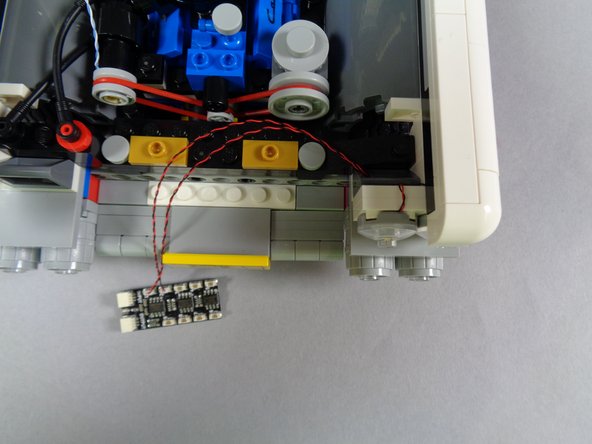 The second and third photos for this step show how your setup should look after re-attaching the first headlight assembly.