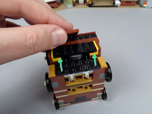 As shown by the green arrows in the second photo for this step, the black plate might bend slightly sitting on top of the magnet (the magnet may be slightly taller than the distance below the black plate).  This is ok, and you should be able to re-attach all LEGO pieces so they hold in place even if the black plate bends slightly.