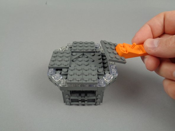 As shown in the photos for this step, continue disassembly by removing the eight 2x3 LEGO plates.