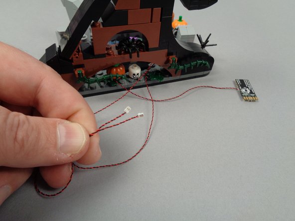 The second photo shows both wires pulled through to the back side.