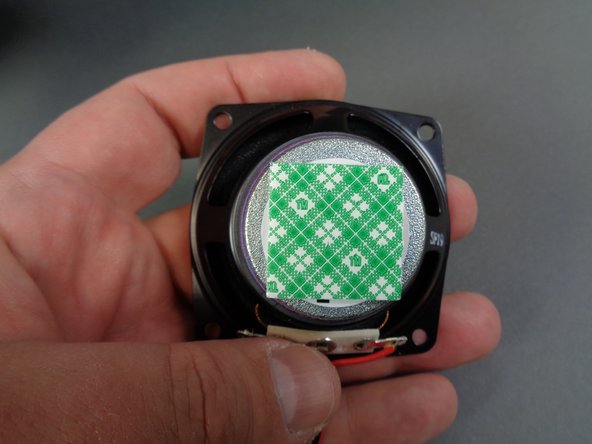 As shown in the first photo, take one of the large double-sided tape squares from the Main Control and Connecting Parts bag, and attach it to the back of the &quot;engines&quot; sound module speaker.