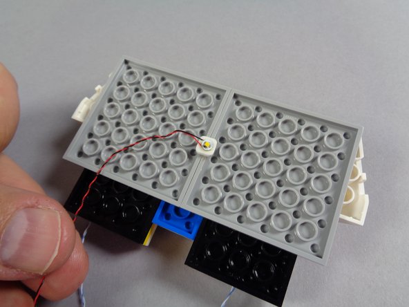 Inside your &quot;Roof Parts&quot; bag, there will be three warm white Pico LED lights: two with shorter wires and one with a longer wire.  You will use the LED light with the longer wire for this step.