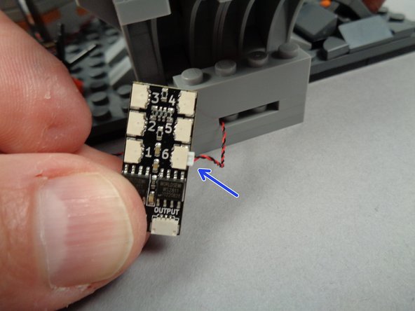 As shown by the arrow in the second photo for this step, connect the first green LED light to plug #6 on the BRANCH06X driver board.