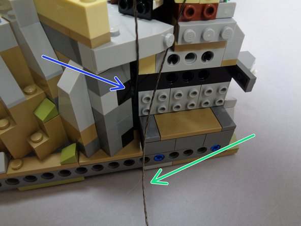 If needed, you can remove the round tan brick at the top of the tower in order to feed the cables through the space underneath.