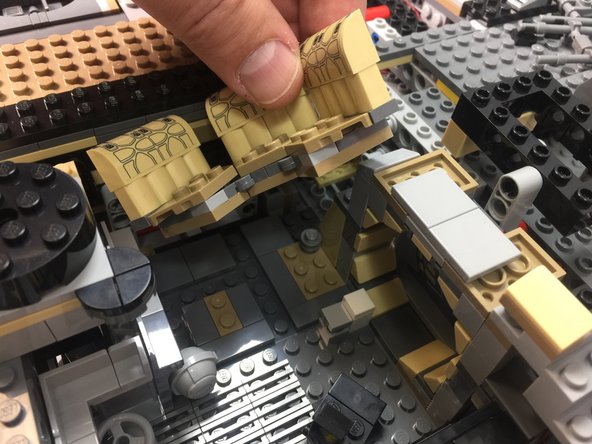 As shown in the photos for this step, remove the seats from the front interior room, re-attach the Dejarik holochess table, and run the light wire under the seat area and out into the exterior section in front of the left docking bay.
