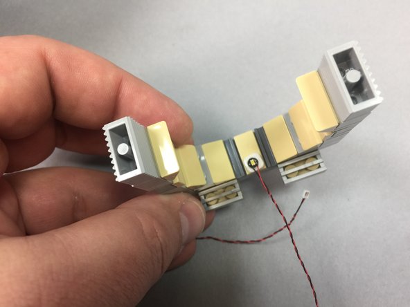 Use another small sticky square to attach a Pico LED light to the top rear of the door frame, then replace the frame.