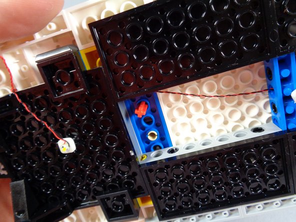 Be careful not to pinch any wires when re-inserting the axle.  As shown in the first photo, make sure all wires pass on the outside of the axle-- do not let them get pinched between the gears.