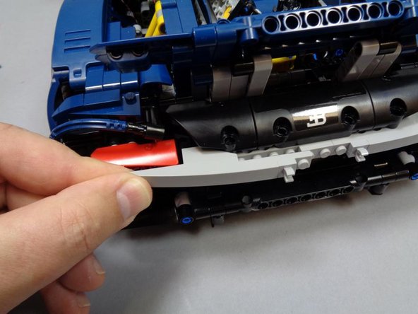 As shown in the two photos for this step, re-assemble the left turn signal assembly.