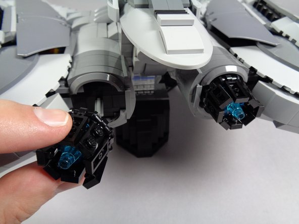 As shown in the first two photos for this step, carefully remove the two engine assemblies from the back of your Raider.